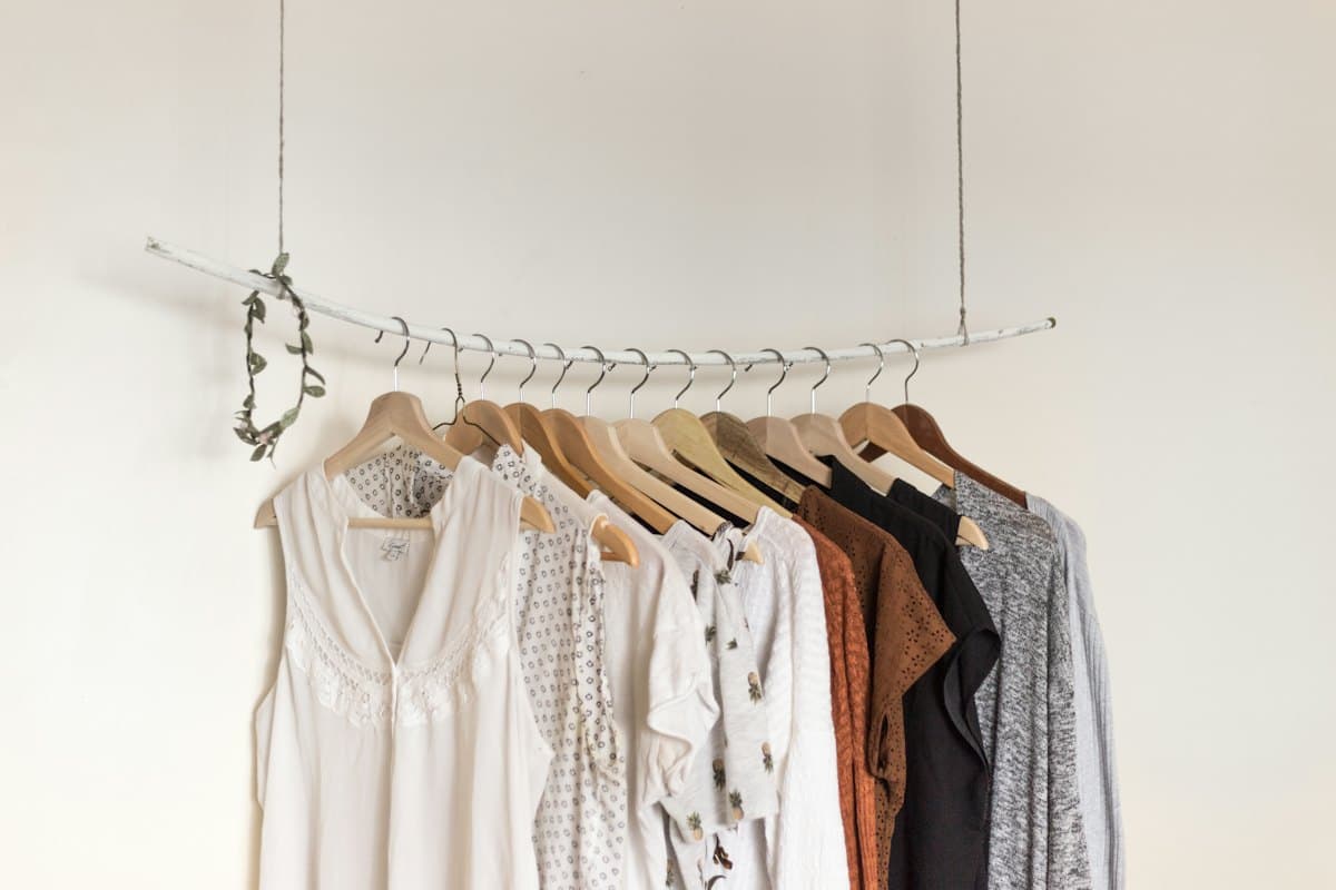 Blouses and shirts on wooden hangers